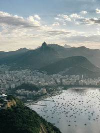 Scenic view of river and mountains against sky