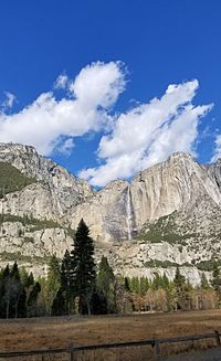 Scenic view of snowcapped mountains against blue sky