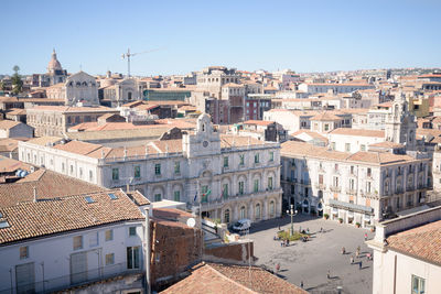 High angle view of buildings in city against clear sky