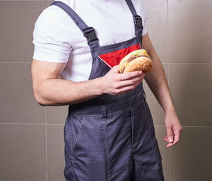 Midsection of man holding ice cream