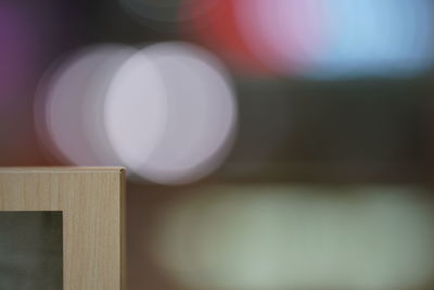 Close-up of illuminated light bulb on table