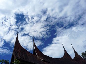 Low angle view of building against cloudy sky