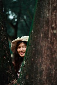 Portrait of smiling young woman in forest