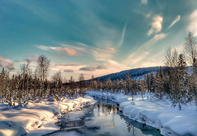 Scenic view of frozen lake against sky during winter