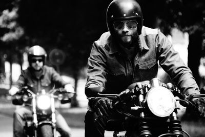 Man riding motorcycle in city at night