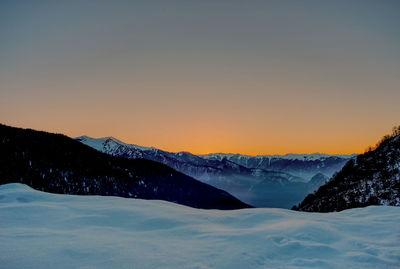 Scenic view of mountains against clear sky during sunset