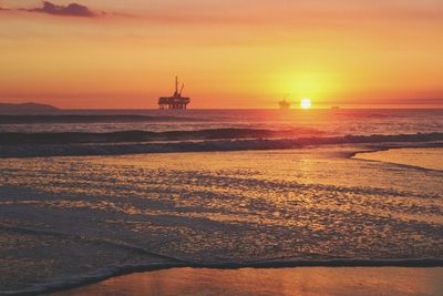 Scenic view of sea against orange sky