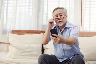 Mid adult man using mobile phone