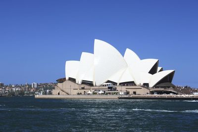 Buildings against clear blue sky
