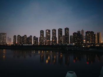 Reflection of illuminated buildings in city at night