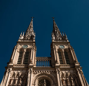 Low angle view of temple building against blue sky