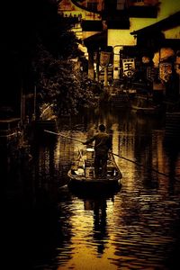 Rear view of boating in canal