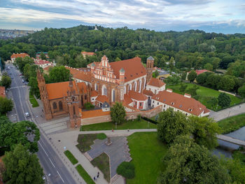 Vilnius old town and st. anne church with hill of three crosses in background. lithuania.