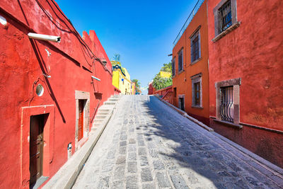 Empty alley amidst buildings in city