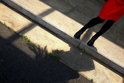 Low section of woman standing on step