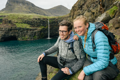 Portrait of smiling man with woman in mountains