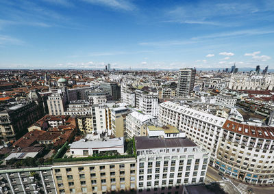 Aerial view of cityscape against sky during sunny day