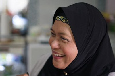 Close-up of smiling mature woman wearing hijab