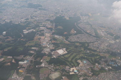 Aerial view of river amidst buildings in city