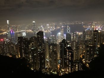 High angle view of illuminated cityscape against sky at night