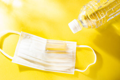 Close-up of yellow bottle on table