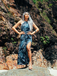 Portrait of young trans woman standing on rock