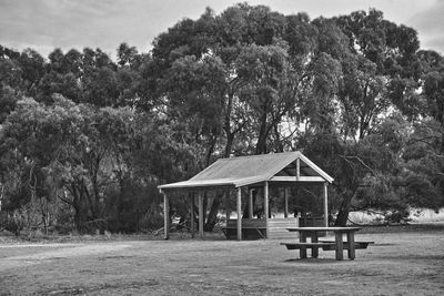 Gazebo on field against trees