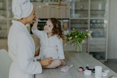 Smiling mother with daughter at home