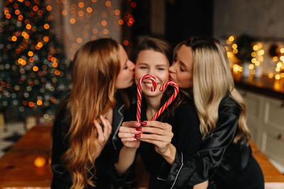 Happy funny girls celebrate christmas holidays and new year in a cozy house