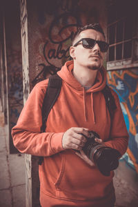 Young man wearing sunglasses standing outdoors