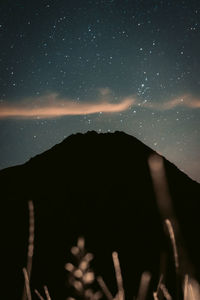 Scenic view of silhouette mountain against sky at night