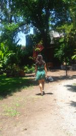 Full length rear view of man walking in park