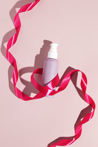 High angle view of red ribbon against white background