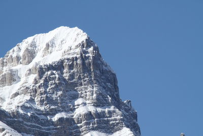 Scenic view of snow mountains against clear blue sky