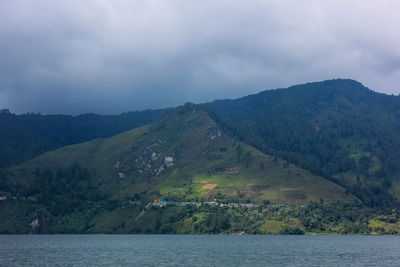 Scenic view of lake and mountains against sky