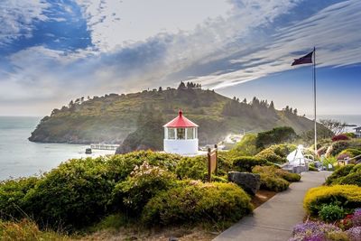 Scenic view of sea and mountains against sky