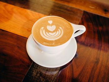 Close-up of coffee cup on wooden table