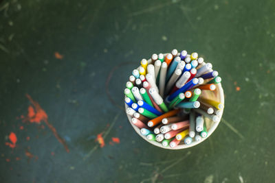 Directly above shot of colorful felt tip pens in desk organizer on table