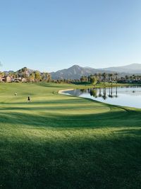 Scenic view of golf course against sky