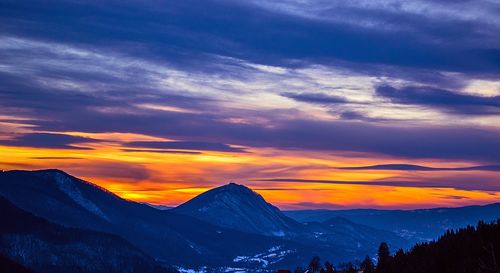 Scenic view of snowcapped mountains against sky during sunset