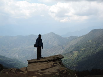 Man standing on mountain against sky