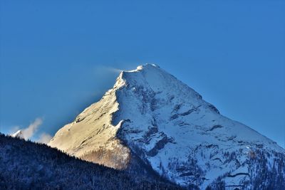 Scenic view of snowcapped mountains against clear blue sky