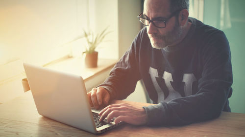 Man working with computer and sitting at home