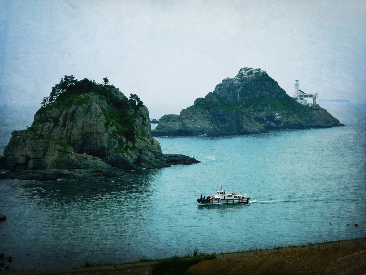 water, sea, nautical vessel, transportation, boat, mode of transport, scenics, tranquil scene, tranquility, rock formation, beauty in nature, rock - object, nature, cliff, sky, mountain, men, rock, horizon over water