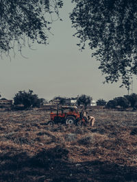 Tractor on field against sky