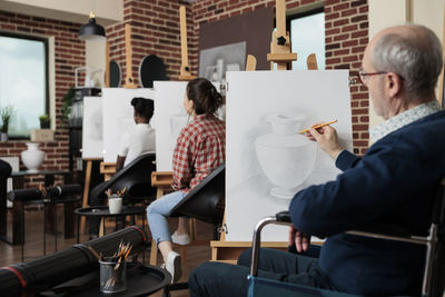Artists painting in class