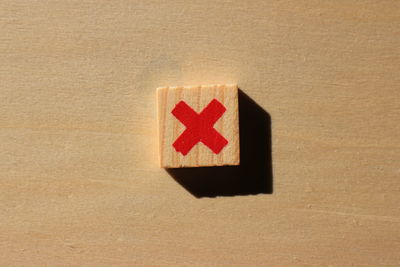 Close-up of multiplication sign on wood