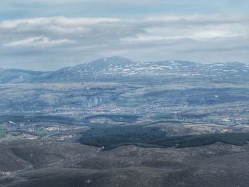 Scenic view of mountains against cloudy sky