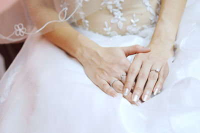 Midsection of bride with hands on lap