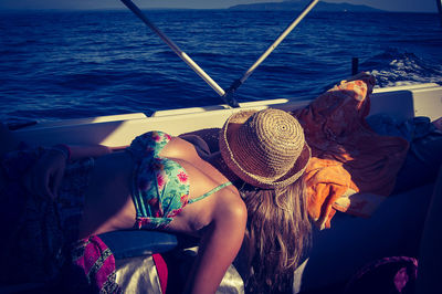 Woman sitting on boat in sea